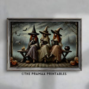 May include: A framed print depicts three witches in hats and gowns, seated on a bench, each holding a glass of wine. The artwork has a dark, autumnal color palette with pumpkins and bats, evoking a Halloween theme. The text "THE PRAMAA PRINTABLES" is at the bottom.