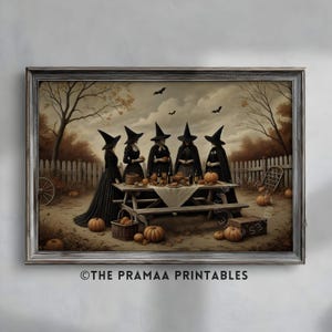 May include: A framed print depicts a gathering of witches around a picnic table. The scene is set outdoors with pumpkins, bats, and a white picket fence. The witches wear black cloaks and hats. The text "THE PRAMAA PRINTABLES" is at the bottom.