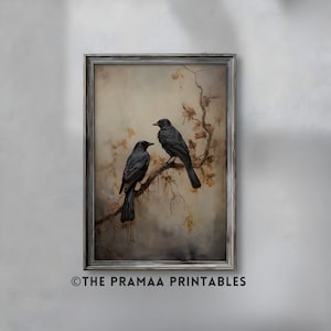May include: A framed print of two black birds perched on a branch with brown leaves. The background is a soft, muted brown and beige with a hazy, atmospheric effect. The frame is a simple, silver-grey color.