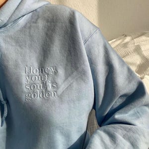 Embroidered personalized sweater with custom text in unisex sizes for women and men