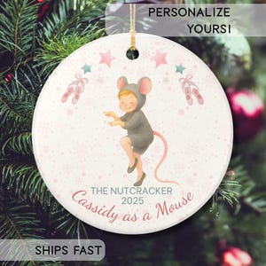 May include: A white ceramic mug with a black handle and the text "But First, Coffee" in a black, bold font. The mug is sitting on a wooden surface. The mug is approximately 4 inches tall.