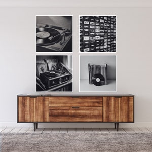 May include: A four-panel wall art set featuring black and white images of vintage audio equipment. The images include a record player, a wall of cassette tapes, and vinyl records. The art is displayed above a wooden cabinet with a dark gray top.