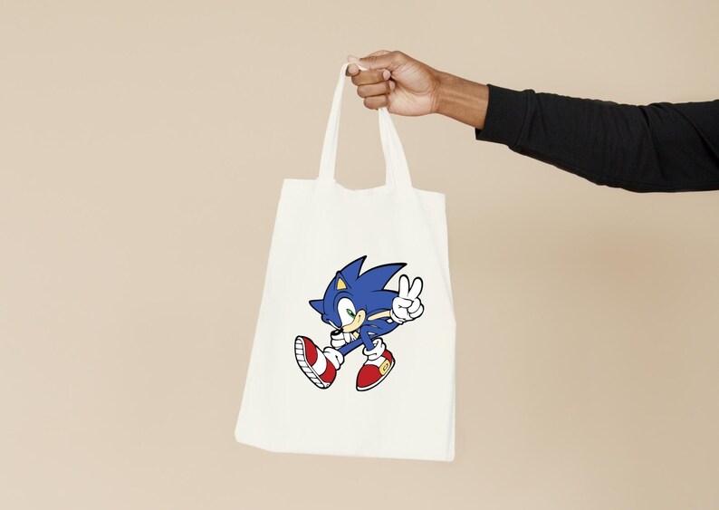May include: White tote bag with a blue and red cartoon image of Sonic the Hedgehog giving a peace sign.