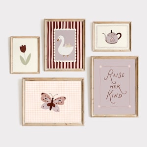 May include: A collection of framed art prints featuring whimsical illustrations. The prints include a tulip, a goose with goslings, a teapot, a butterfly, and the text "Raise Her Kind". The frames are wooden, and the artwork has a soft, pastel color palette.