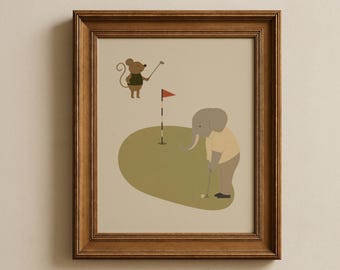 May include: A framed wall art print featuring a cartoon illustration of a brown mouse and a gray elephant playing golf on a green putting surface. The mouse holds a golf club, while the elephant prepares to putt a ball near a flag with a red pennant.