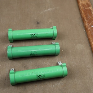 May include: Three green cylindrical resistors with black markings. The resistors are labeled with the text "110 70 30KOhm" and "2.75 545271" and "110 70 30KOhm".
