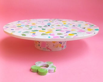 Round terrazzo cake stand for cakes, muffins, and fruit on a round, removable base.