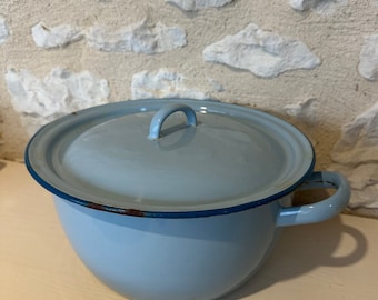 May include: A light blue enamel pot with a lid and two handles. The pot has a blue rim and a small amount of rust on the rim.