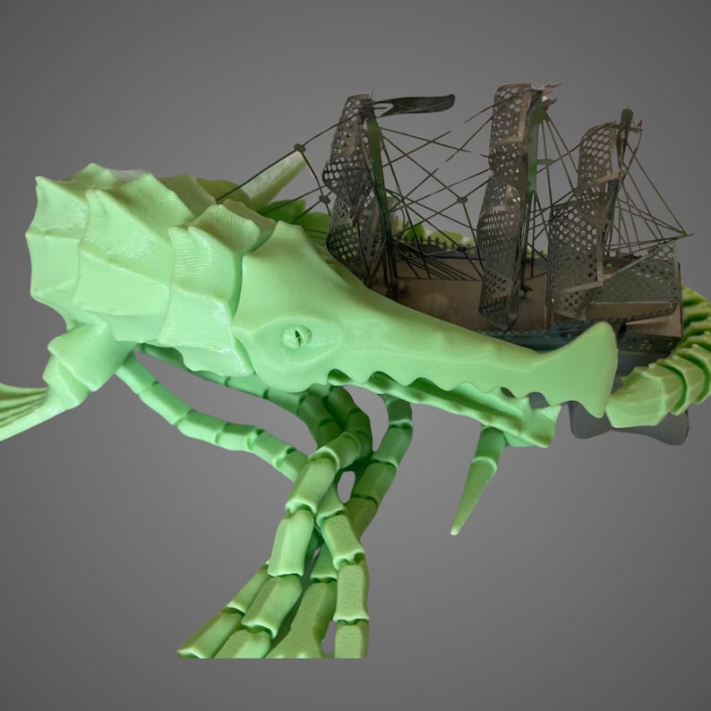 May include: A 3D printed green skeletal creature with a ship inside its mouth. The creature has a long tail and multiple legs.