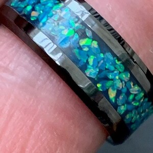 May include: Black tungsten ring with a green and blue opal inlay.