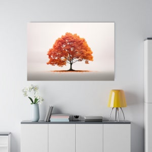 May include: A single orange tree with leaves in shades of orange and red stands alone against a white background. The tree is in the center of the image and is surrounded by a light fog.