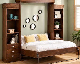 May include: A dark wood Murphy bed with built-in bookshelves on either side. The bed is made up with white bedding and yellow patterned pillows. The wall behind the bed has several round mirrors. A small clock and potted plant sit on the shelves.