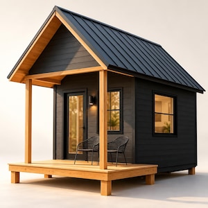 May include: A small cabin with black horizontal siding and a dark metal gable roof. It features a natural wood porch with two black wire chairs, a glass-panelled door, and two windows with black frames. The structure is elevated on wooden posts.