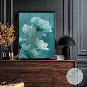 A teal botanical digital art print featuring delicate line-drawn flowers with soft, textured petals set against a smooth teal background. The artwork is displayed in a gold frame on a white paneled wall, creating a modern, elegant, nature-inspired aesthetic. Perfect for living room, bedroom, or entryway decor. Digital download floral wall art with soft teal tones and minimalistic botanical style.