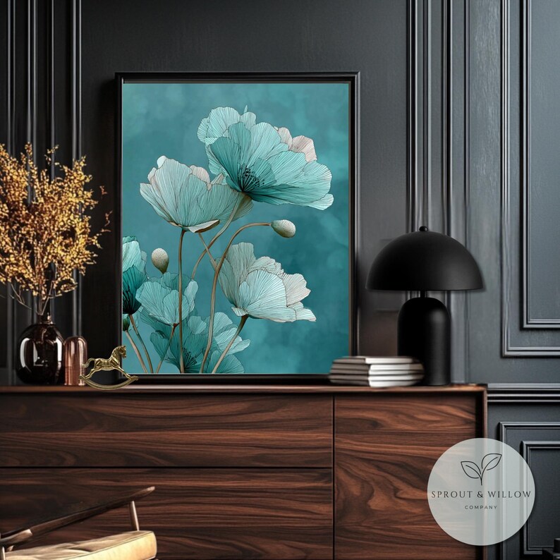 A teal botanical digital art print featuring delicate line-drawn flowers with soft, textured petals set against a smooth teal background. The artwork is displayed in a gold frame on a white paneled wall, creating a modern, elegant, nature-inspired aesthetic. Perfect for living room, bedroom, or entryway decor. Digital download floral wall art with soft teal tones and minimalistic botanical style.