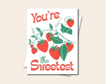 May include: A red and green greeting card with the text "You're the Sweetest" and a vine of red strawberries.