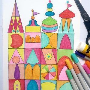 Puede incluir: Un dibujo de un castillo geométrico colorido sobre papel blanco con una variedad de marcadores de colores y un pegamento en barra al lado.
