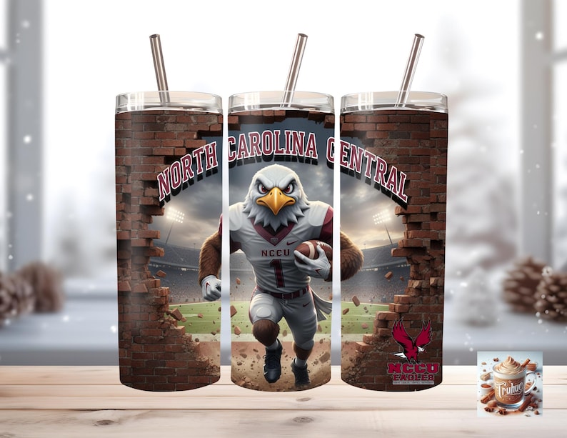 May include: A stainless steel tumbler with a straw, featuring a design of the North Carolina Central Eagles mascot breaking through a brick wall. The tumbler includes the text "NORTH CAROLINA CENTRAL" and "NCCU EAGLES".