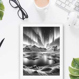 May include: A black and white photo of a mountain range with a lake in the foreground. The sky is filled with the aurora borealis, a natural light display in the sky, predominantly seen in the high-latitude regions (around the Arctic and Antarctic).