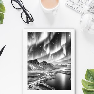 May include: A black and white digital drawing of the Northern Lights over a snowy landscape with a lake and a small village. The drawing is displayed on a tablet computer.