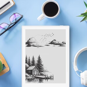May include: A digital tablet displays a black and white landscape illustration of clouds and a cabin by a lake. A cup of coffee, glasses, a pen, a green apple, a succulent, and headphones are arranged on a light blue surface.