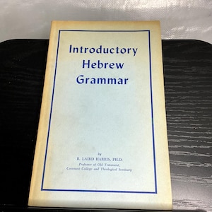 May include: A softcover book titled Introductory Hebrew Grammar by R. Laird Harris, Ph.D., Professor of Old Testament, Covenant College and Theological Seminary. The cover is light blue with a dark blue border and dark blue text.