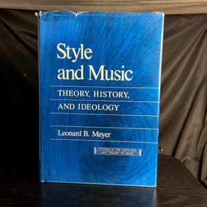 May include: A hardcover book titled "Style and Music" with a blue cover. The book's title and subtitle, "THEORY, HISTORY, AND IDEOLOGY," are in white text. The author's name, Leonard B. Meyer, is also visible. The book is part of the "STUDIES IN THE CRITICISM AND THEORY OF MUSIC" series.