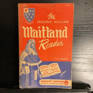 May include: A vintage book titled "The Frederic William Maitland Reader" with a red cover. The cover features a portrait of a robed figure, the book's title in large, cream-colored letters, and the author's name. The book is part of the Docket Series.