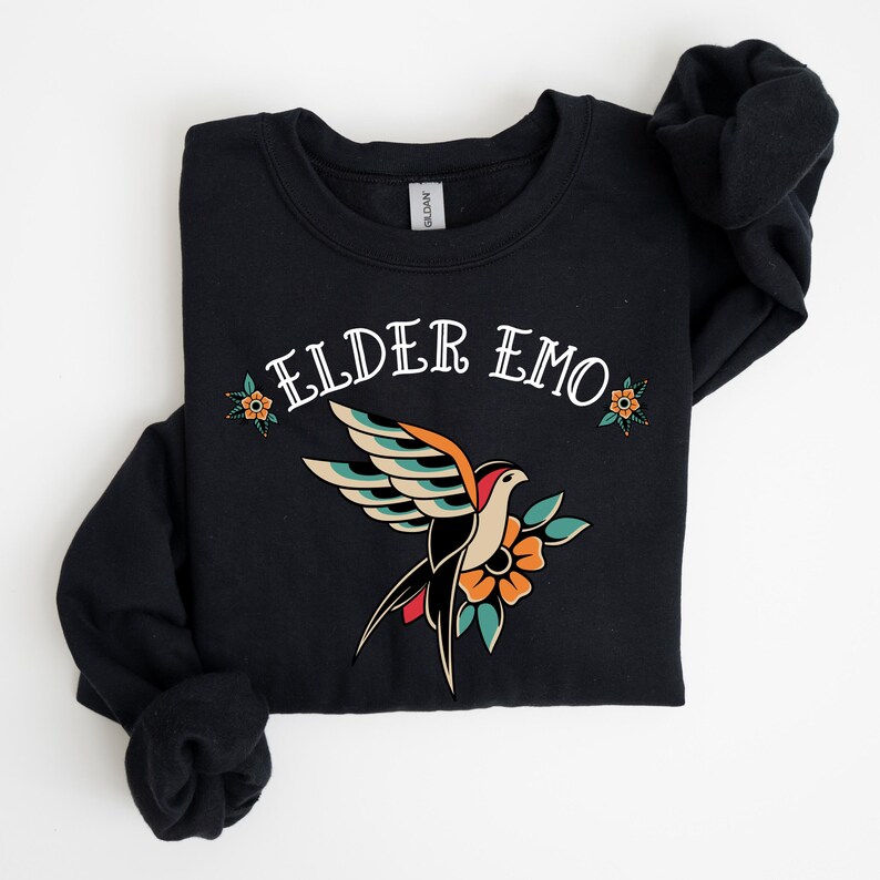 May include: Black sweatshirt with a white graphic of a bird with flowers and the text "Elder Emo".