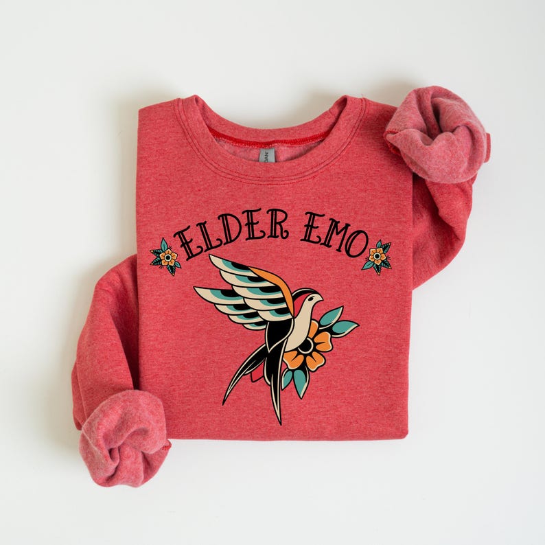 May include: Red sweatshirt with a vintage-style bird and flower graphic and the text "ELDER EMO" in black.