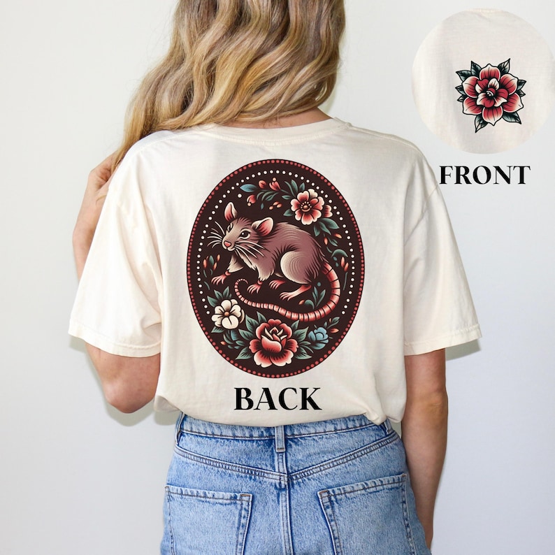May include: A cream-colored t-shirt with a floral design featuring a rat in the center. The back of the shirt says "BACK" and the front says "FRONT".