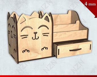 May include: A wooden desk organizer with a cat face design. The organizer has three compartments and a drawer. The organizer is made for 4 mm plywood.