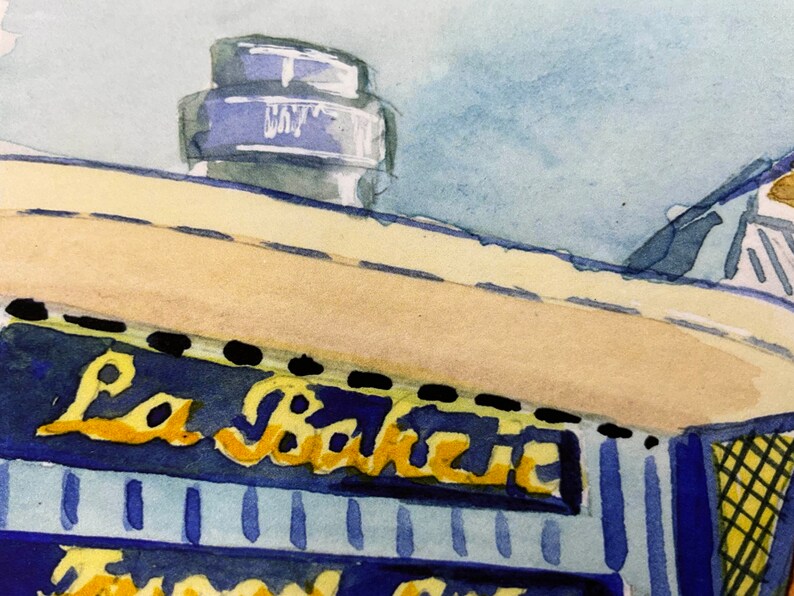 May include: A watercolor painting of a building with a sign that reads "La Baguette". The building is painted in shades of blue and yellow, with a white roof. The sign is painted in gold lettering.