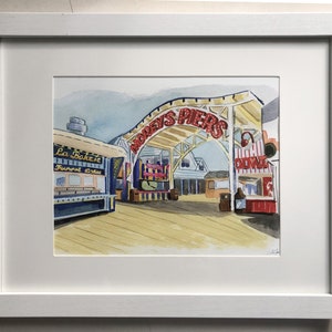 May include: Watercolor painting of a boardwalk scene with a red and white sign that reads "Audrey's Piers". There are several shops and food stands on the boardwalk, including one that says "La Bake-it" and another that says "Chill Zone".