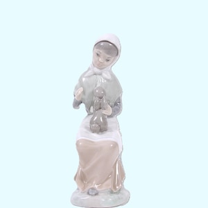 Vintage Lladro Nao Zaphir Woman with Rabbit Figurine #0522G, retired. A young woman sits with her bunny on her lap. 7-3/4&quot; x 2-3/4&quot; x 3-1/4&quot;
