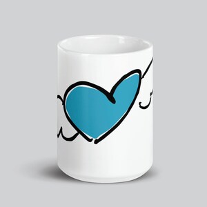 May include: White ceramic mug with a black and white drawing of a cloud with a blue heart inside.