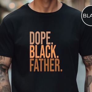 May include: Black t-shirt with the words "DOPE. BLACK. FATHER." in a gradient orange font. The shirt has a crew neck and short sleeves. A black circle with the word "BLACK" is in the upper right corner.