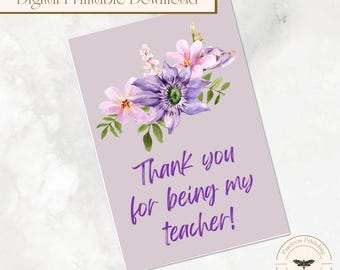 May include: A digital printable card with a lavender background and watercolour floral arrangement. The flowers are purple and pink with green leaves. The text reads "Thank you for being my teacher!"