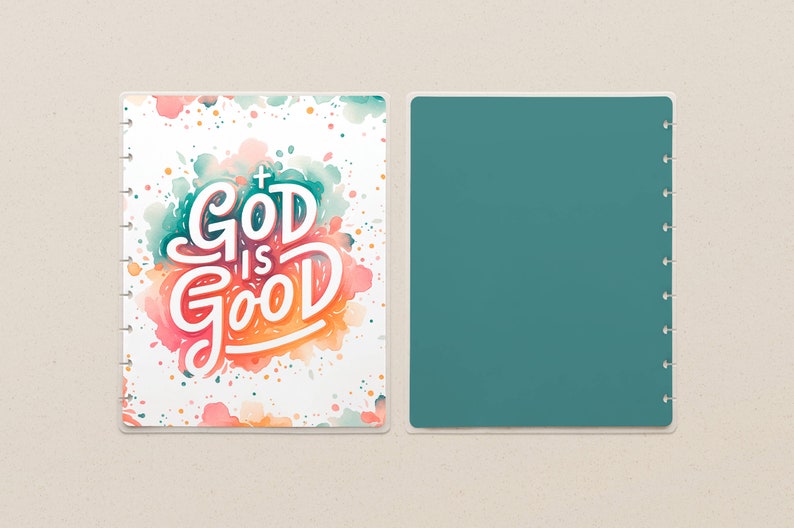 May include: A planner cover with the words "GOD IS GOOD" in white script with a cross, set against a watercolor background of teal, pink, and orange. The opposite side is a solid teal color.