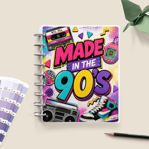 May include: A spiral-bound notebook featuring a colourful graphic design with the text "MADE IN THE 90'S". The cover displays illustrations of a cassette tape, a digital pet, a boombox, a high-top trainer, and a circular pog token on a dotted background.