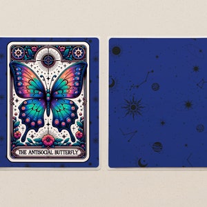 May include: A blue and white planner with a colourful butterfly illustration and the text "The Antisocial Butterfly". The planner has a blue cover with a constellation pattern and a spiral binding.