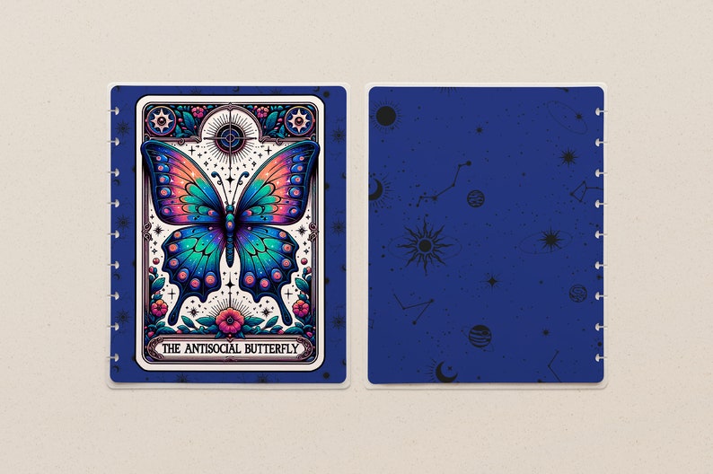 May include: A blue and white planner with a colourful butterfly illustration and the text "The Antisocial Butterfly". The planner has a blue cover with a constellation pattern and a spiral binding.