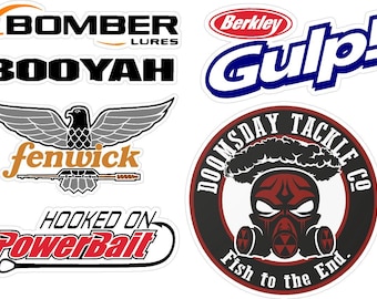 May include: A collection of fishing-themed stickers featuring various brand logos and graphics. The stickers include the "Bomber Lures" logo, the "Booyah" logo, the "Fenwick" logo with an eagle, and the "Hooked on PowerBait" logo.