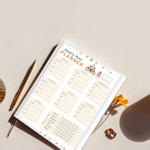 May include: A white weekly meal planner with a whimsical princess and carriage design. The planner includes sections for breakfast, lunch, dinner, and snacks for each day of the week. It also includes a section for tracking water intake.