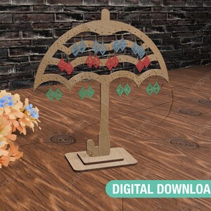 May include: A wooden earring display stand shaped like an umbrella with 12 earring hooks. The stand is brown and has a natural wood finish. The stand is on a wooden surface.