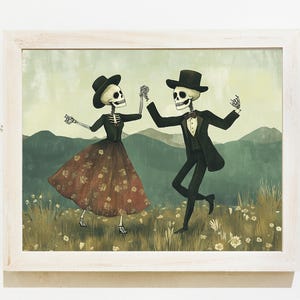 以下が含まれることがあります： 2 人の骸骨がフィールドで踊っているイラストが額装されています。女性の骸骨は赤と茶色のドレスと黒い帽子を着用しています。男性の骸骨は黒いスーツと黒いシルクハットを着用しています。背景は緑のフィールドで、遠くには山が見えます。