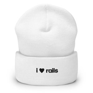 May include: White knit beanie with a black embroidered heart and the text "i ♥ rails" on the cuff.