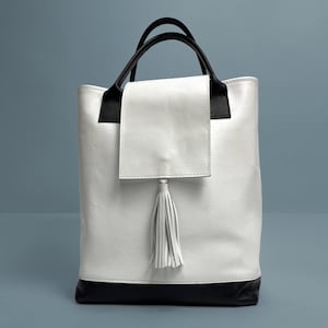 White leather handbag with black accent
