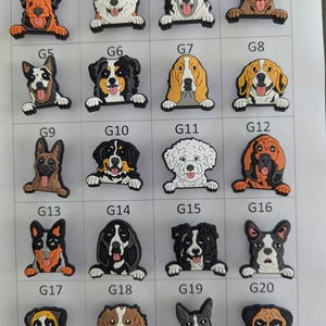 May include: Twenty dog-themed charms, each depicting a different breed. The charms are in various colours, including brown, black, white, and tan. Each charm features a dog's head and paws, with the dog's body hidden.