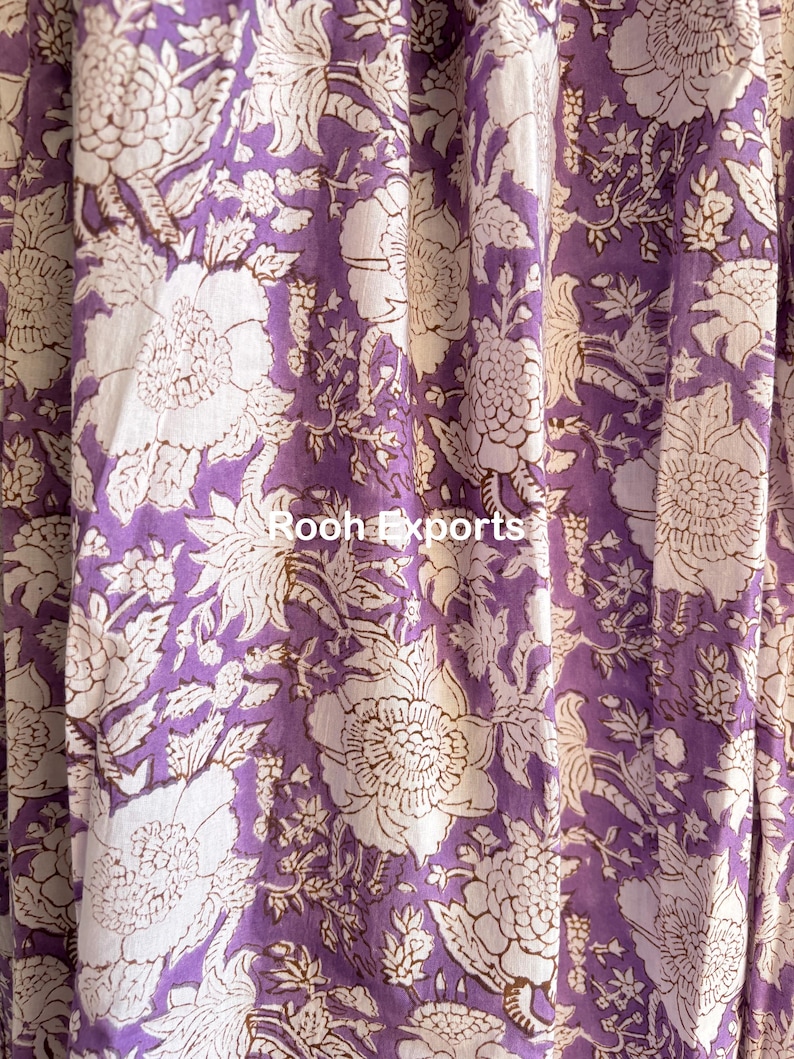 May include: Purple fabric with a white floral pattern. The fabric has a subtle sheen and a soft texture.